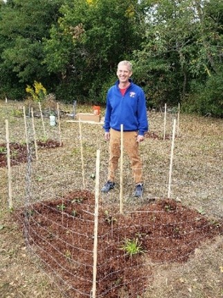 A teacher standing in a garden