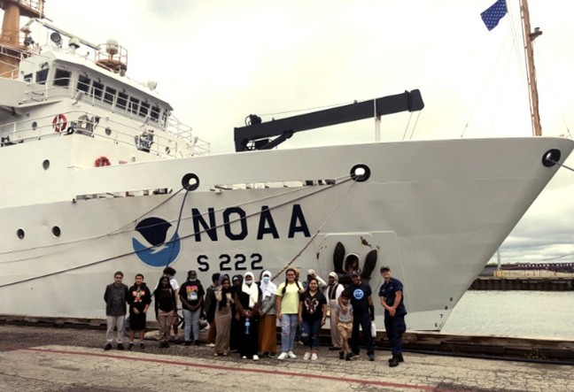 Students in front of a NOAA ship