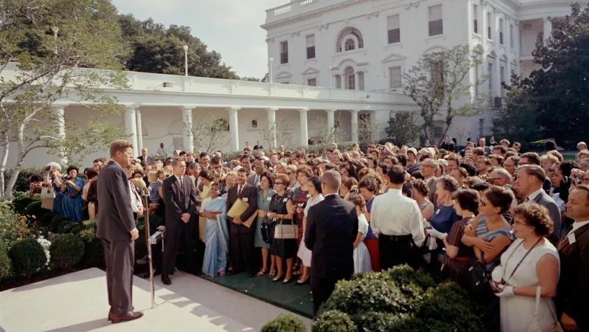 JFK addresses a group at the White House