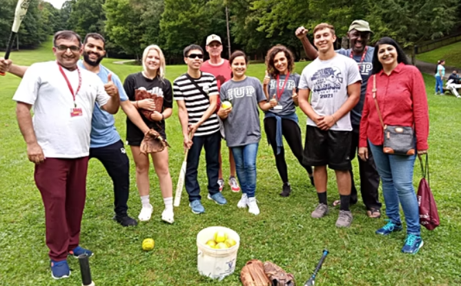 group of teachers outdoors playing baseball