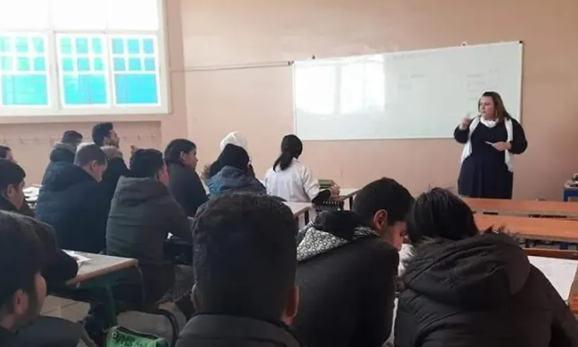 a teacher in front of a classroom of students